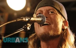 Wes Scantlin net worth 2024 - Puddle of Mudd frontman performing on stage, illustrating his journey from success to financial recovery