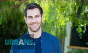 David Giuntoli smiling in a tailored suit at a Hollywood premiere event - the Grimm and A Million Little Things star's net worth has grown substantially through his successful transition from reality TV to leading actor